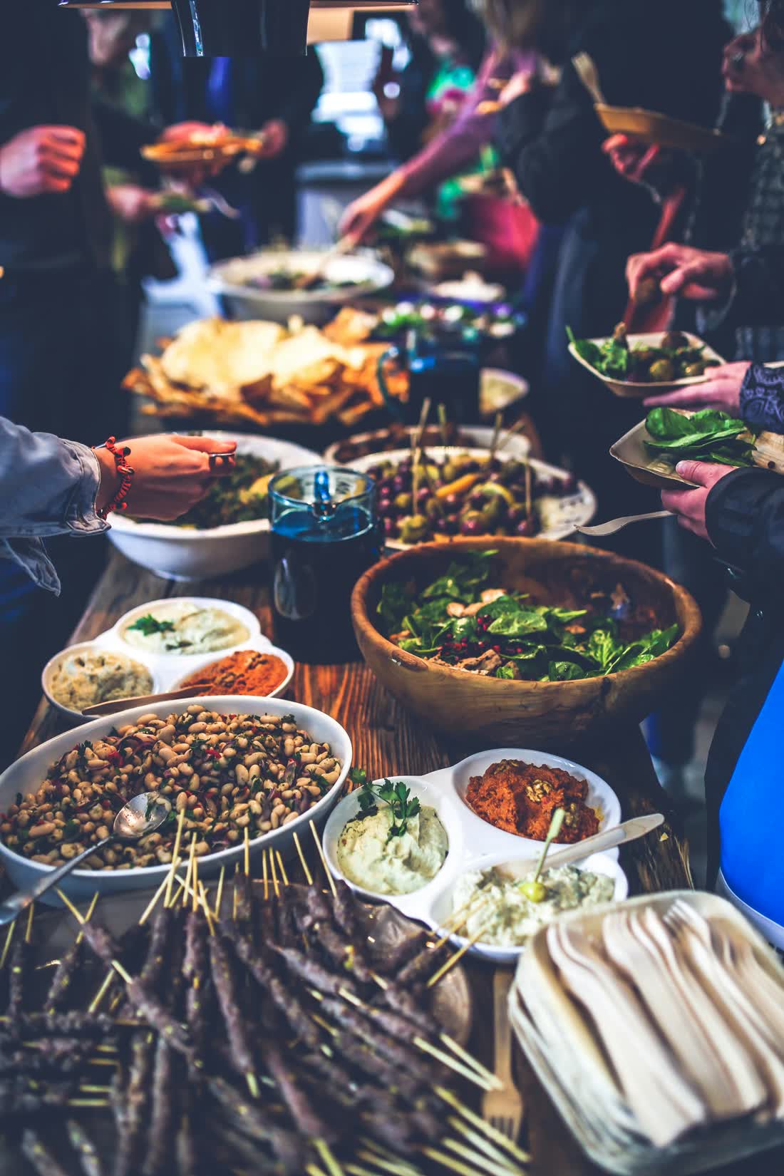 A potluck table covered in shared dishes
