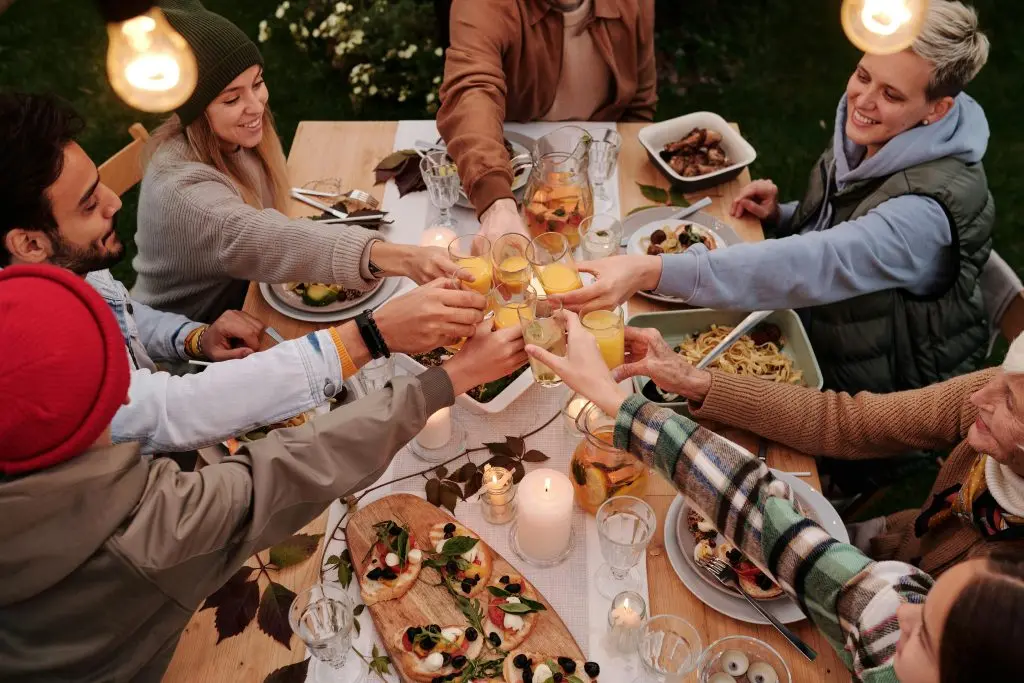 Friends raising glasses over a shared dinner