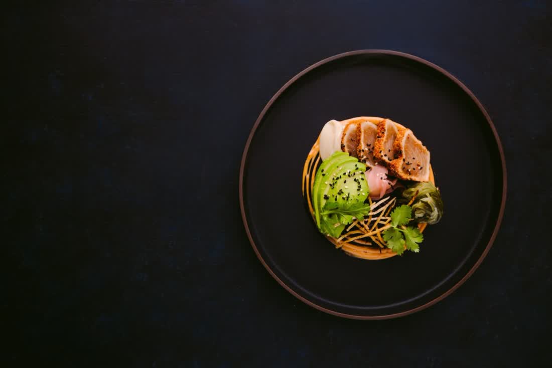 A plated dish on a dark table